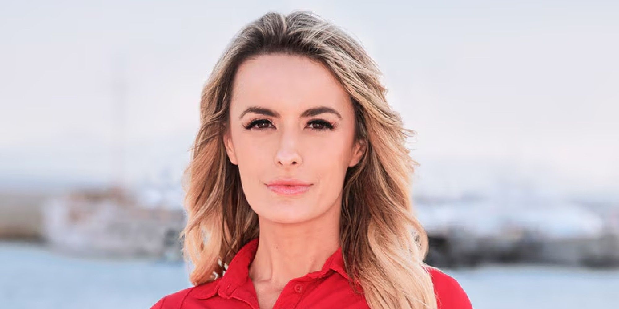 Elena Dubaich below deck med posing for her promo shot with a red shirt