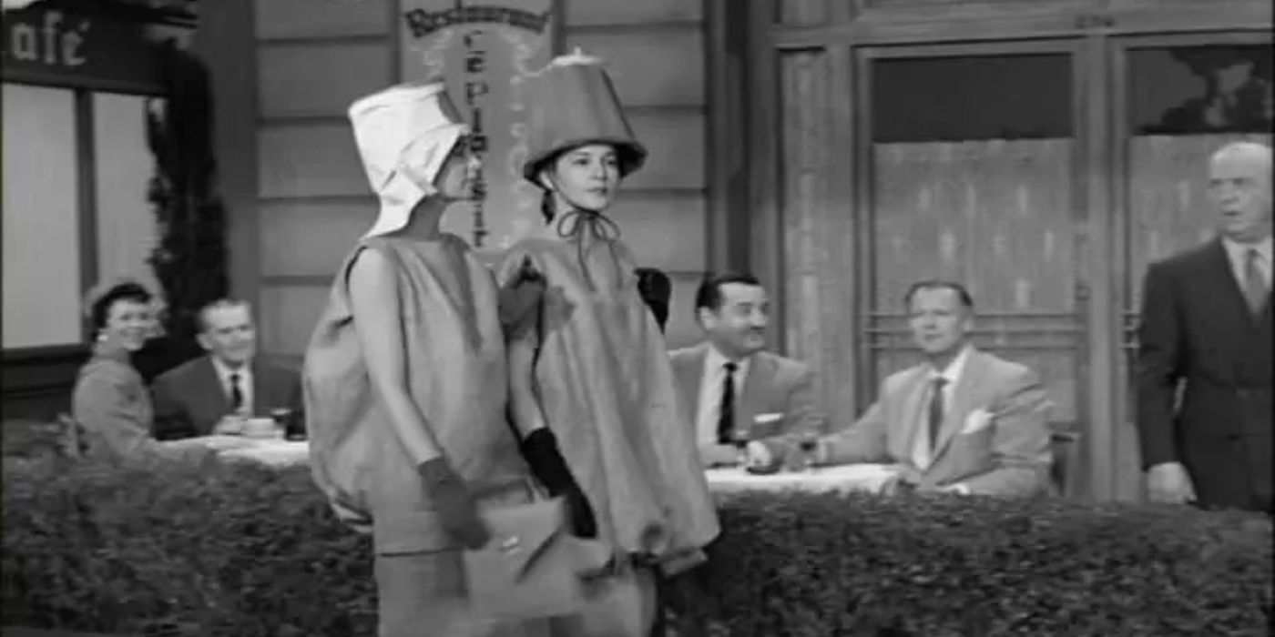 Georgia Holt dressed as a model in a potato sack walking alongside another model as people gape in I Love Lucy.
