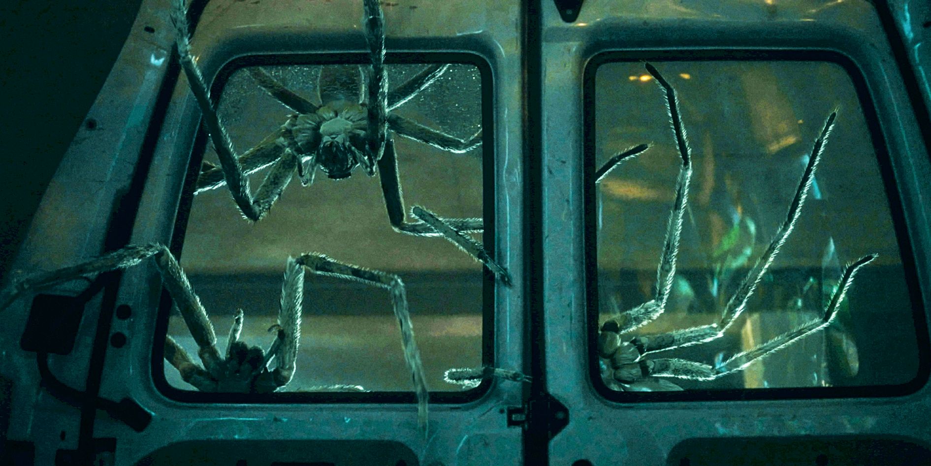Giant spiders crawling into a van's broken window in Infested