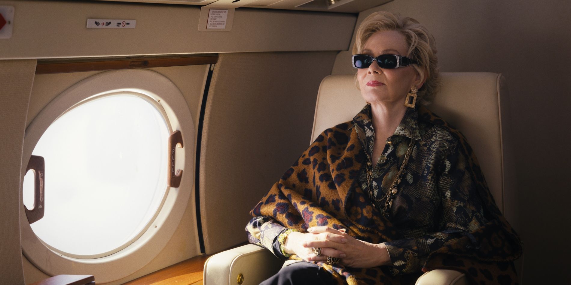 Deborah sits on a private plane in Hacks