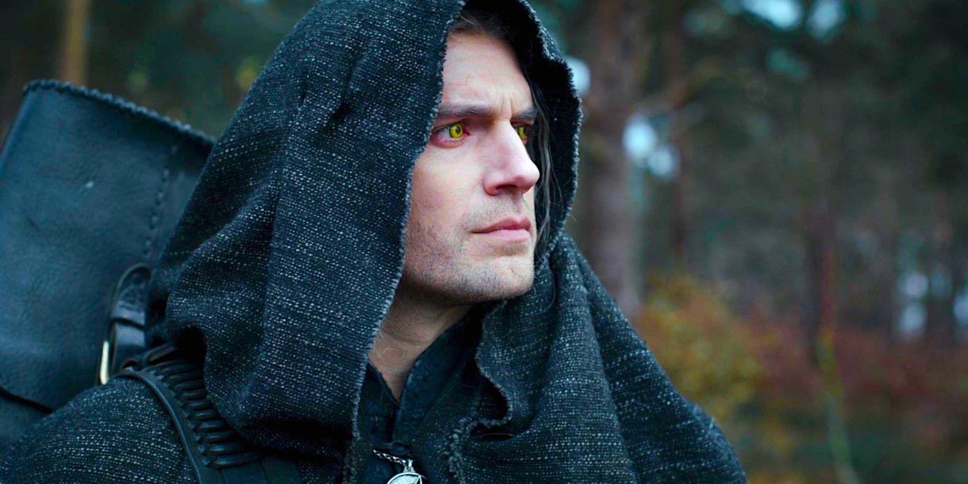 A hooded Henry Cavill gazes forward with a concerned expression in a scene from The Witcher