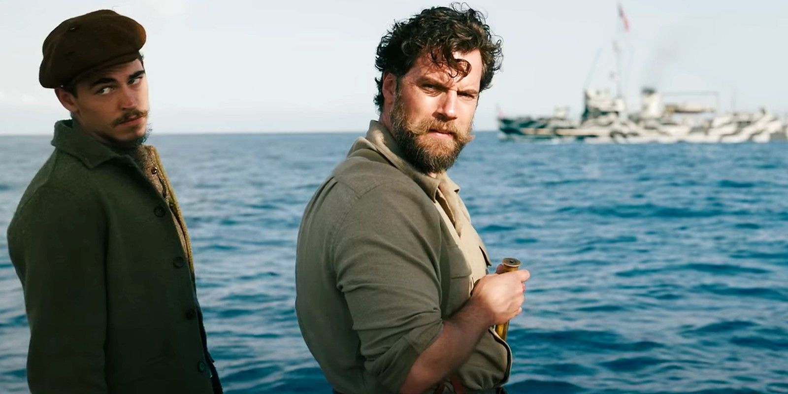 Henry Cavill looking behind the sailing boat in Ministry of Ungentlemanly Warfare