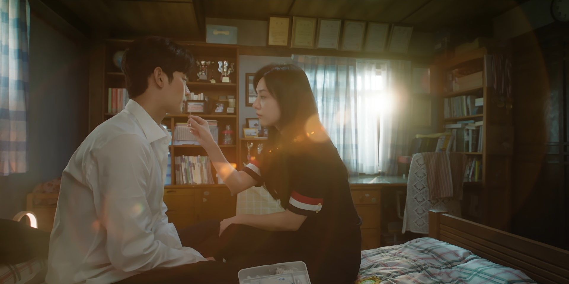 Haein applies ointment to Hyunwoo's lip in Queen of Tears
