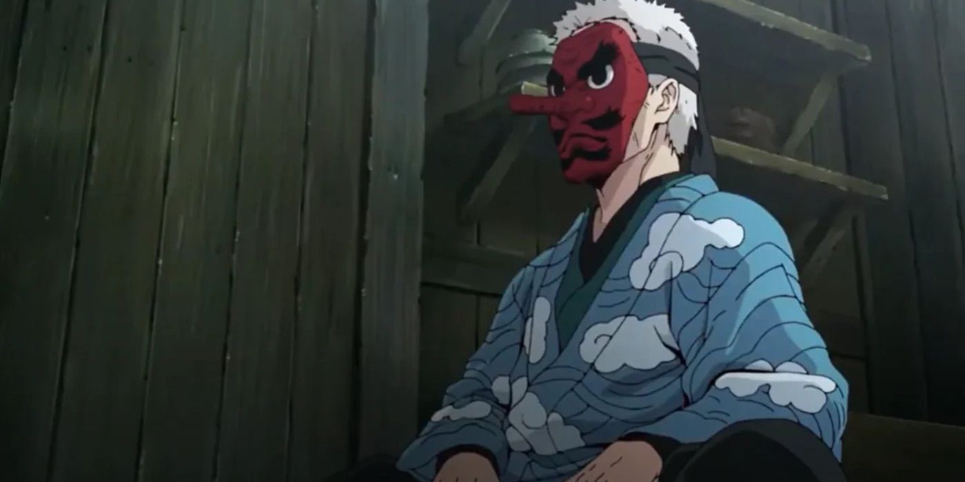 Urokodaki من Demon Slayer ينظر إلى الأمام مباشرة وهو يرتدي كيمونو أزرق