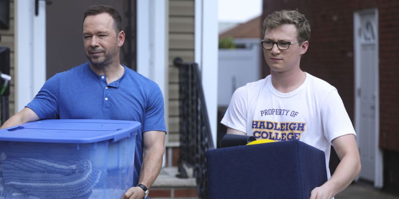 Jack Reagan (Tony Terraciano) and Danny Reagan (Donnie Wahlberg) carrying boxes for colleg move-in in Blue Bloods.