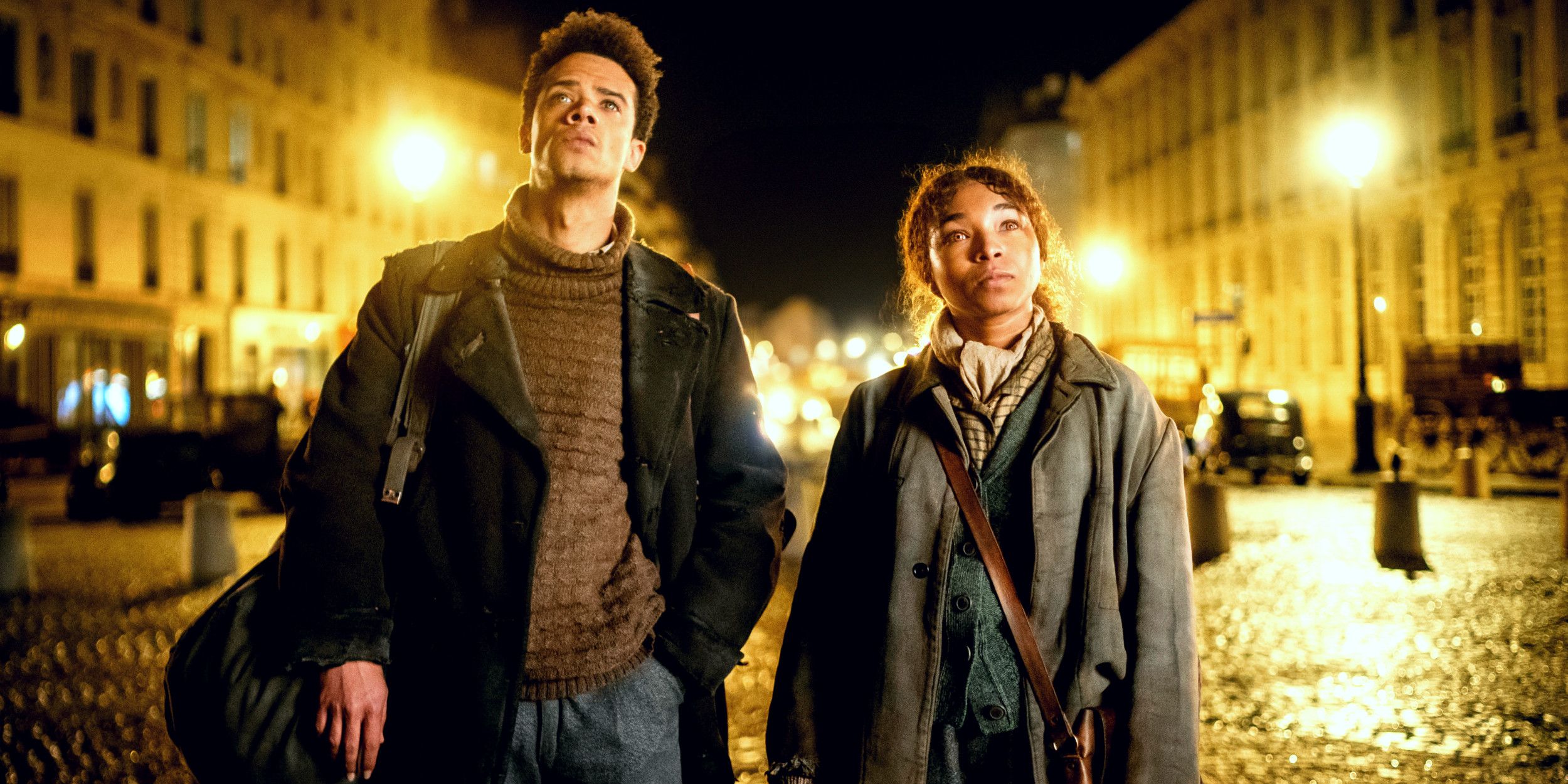 Jacob Anderson as Louis and Delainey Hayles as Claudia looking up while standing in the streets of Paris in Interview with the Vampire season 2