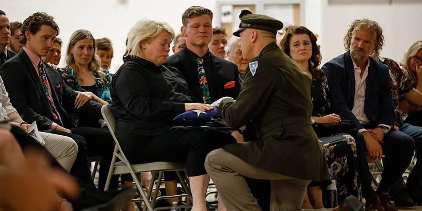 Sister Wives Janelle Brown At Garrison's Memorial receiving his folded flag from a soldier.