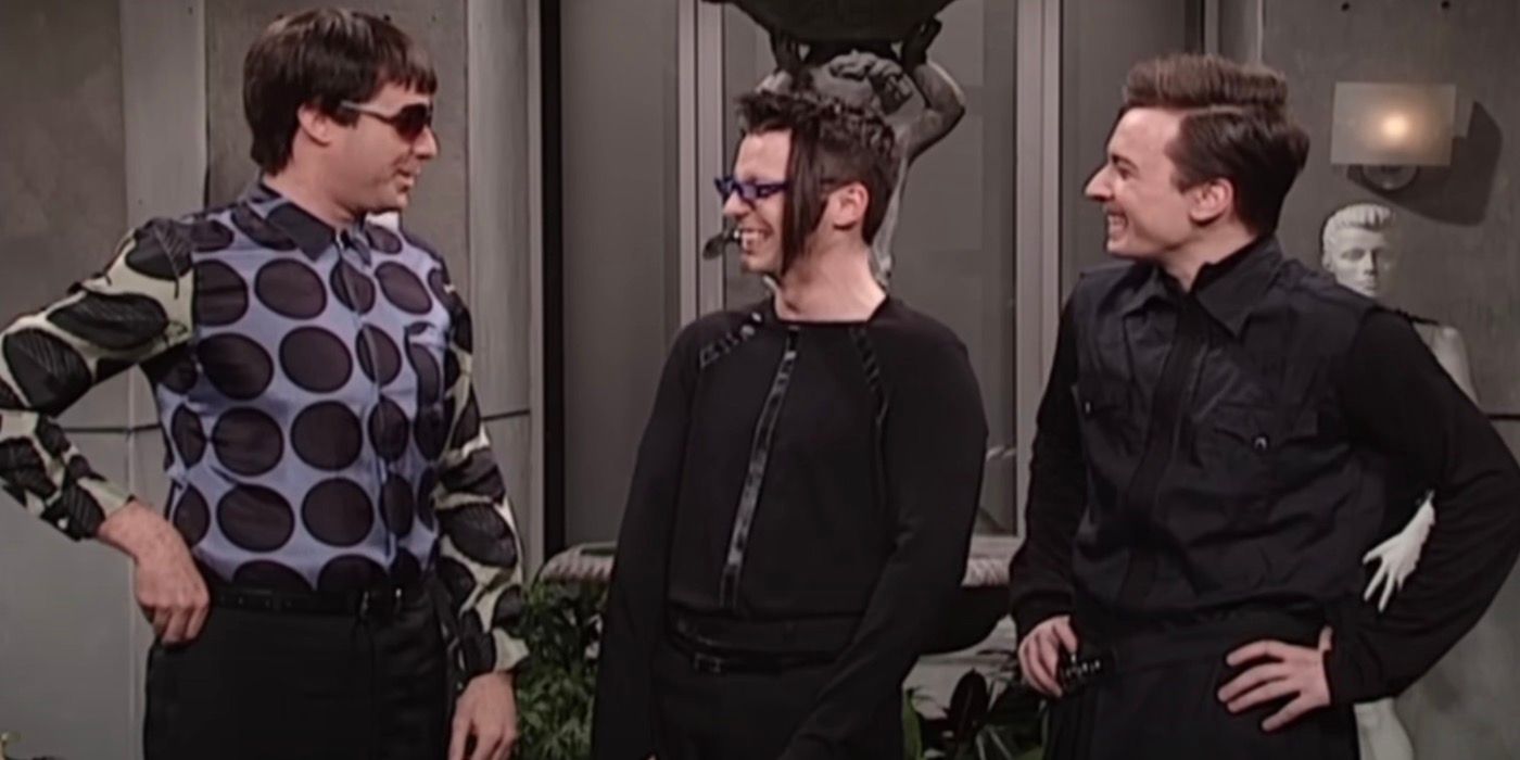 Will Ferrell is standing next to Sean Hayes and Jimmy Fallon as they laugh. 