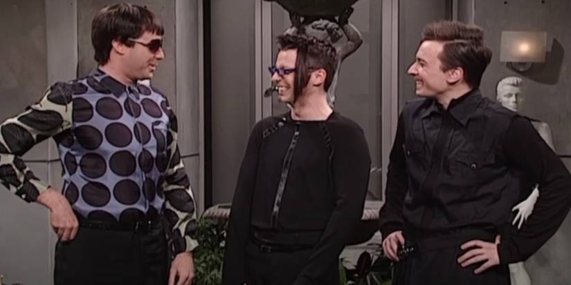 Will Ferrell is standing next to Sean Hayes and Jimmy Fallon as they laugh.