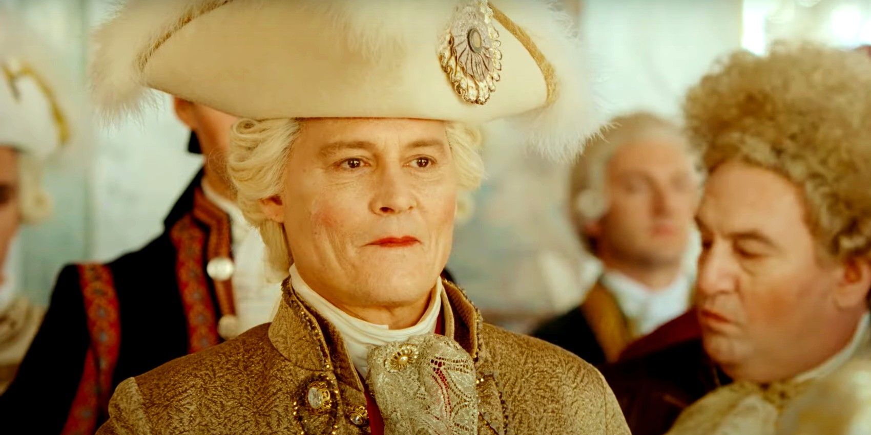 Johnny Depp como um membro da realeza francesa contendo seu sorriso em Jeanne Du Barry