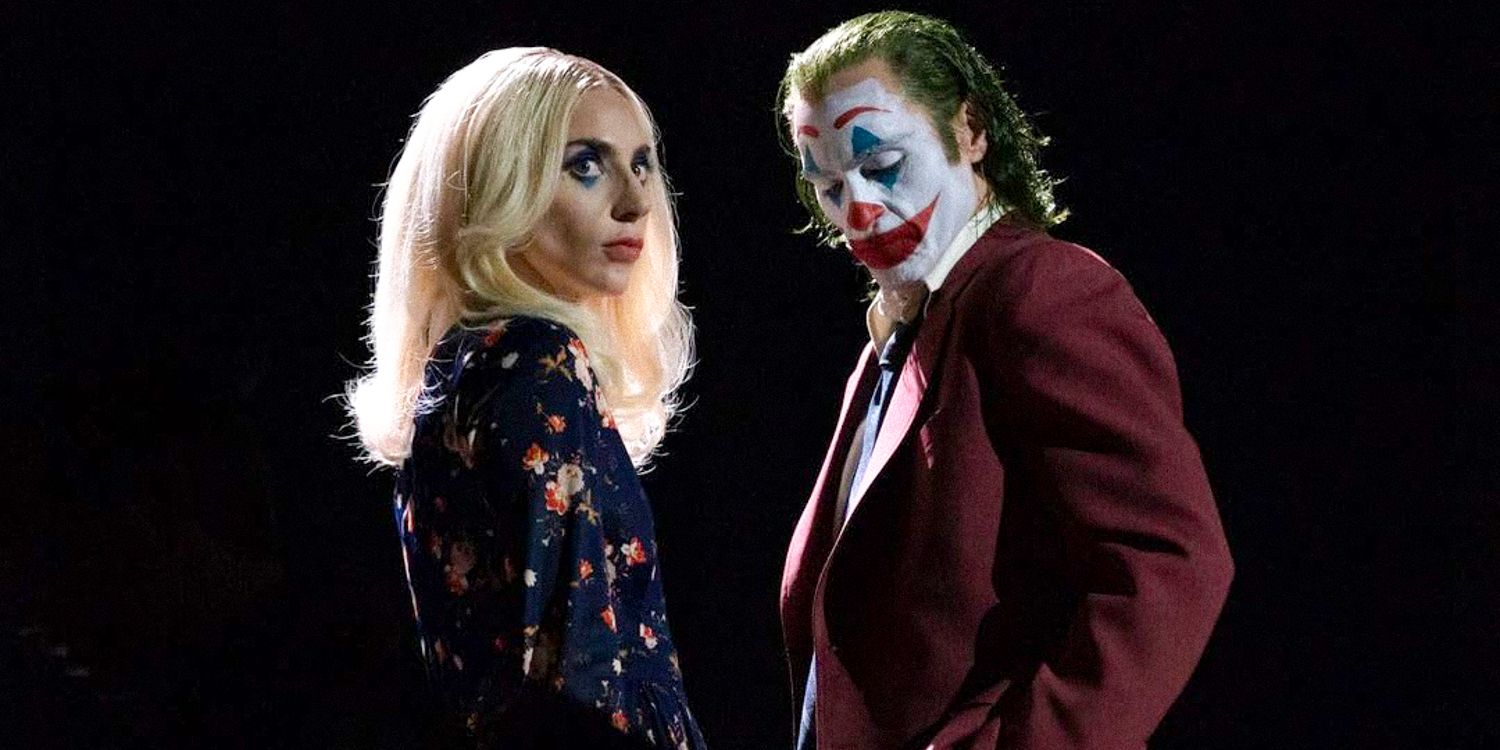 Joker and Harley Quinn standing facing each other against a dark background in Joker: Folie à Deux