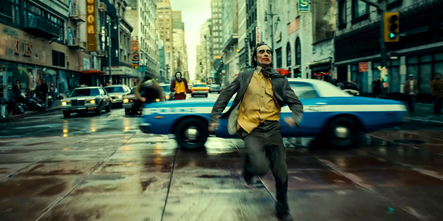 Arthur Fleck as the Joker (Joaquin Phoenix) runs away in fear in Joker: Folie à Deux