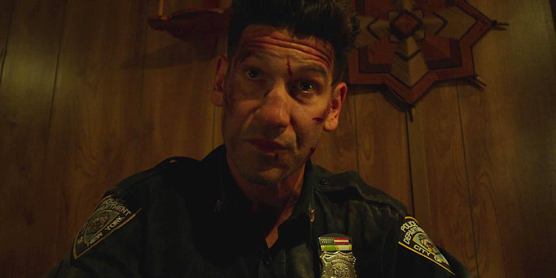Jon Bernthal's Punisher bloody and bruised in a cop uniform in The Punisher season 2 finale