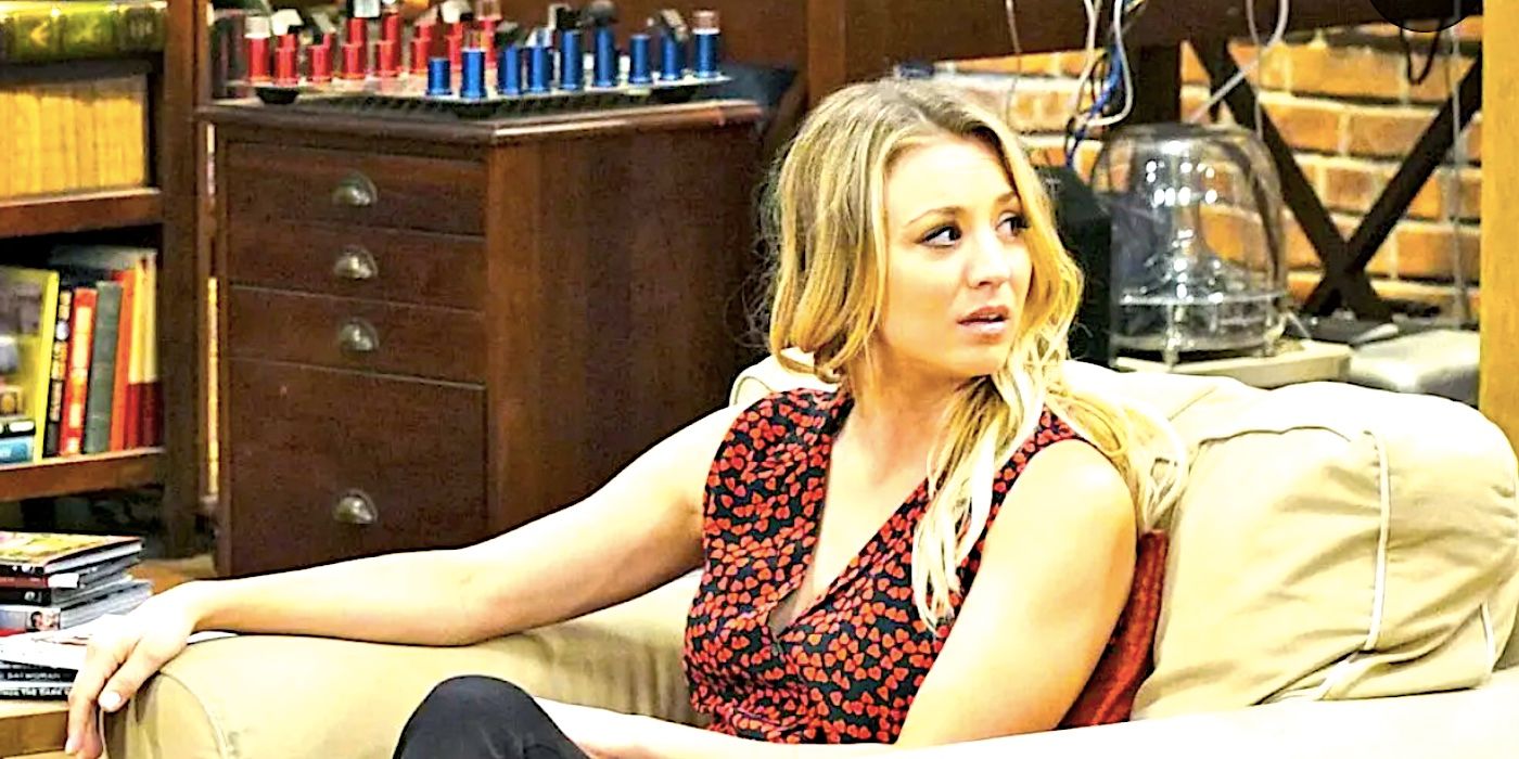 Kaley Cuoco's Penny stares offscreen at something while sitting on a couch in The Big Bang Theory