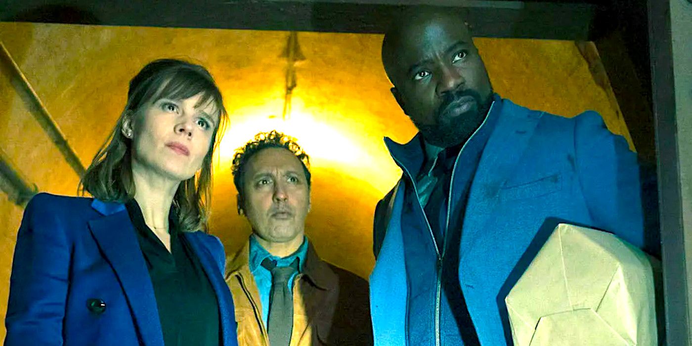 Katja Herbers, Aasif Mandvi and Mike Colter crowd together in a doorway looking outward confrontationally in a scene from Evil season 4