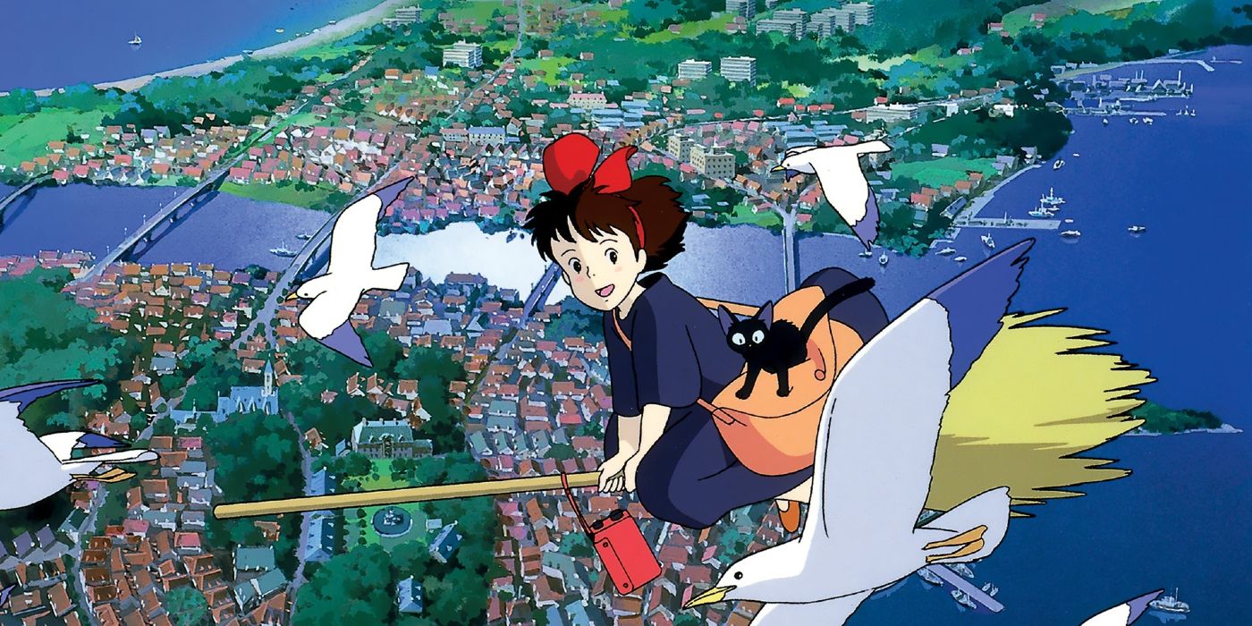 Kiki on a Broom with Jiji Flying with Seagulls while soaring above a seaside town.