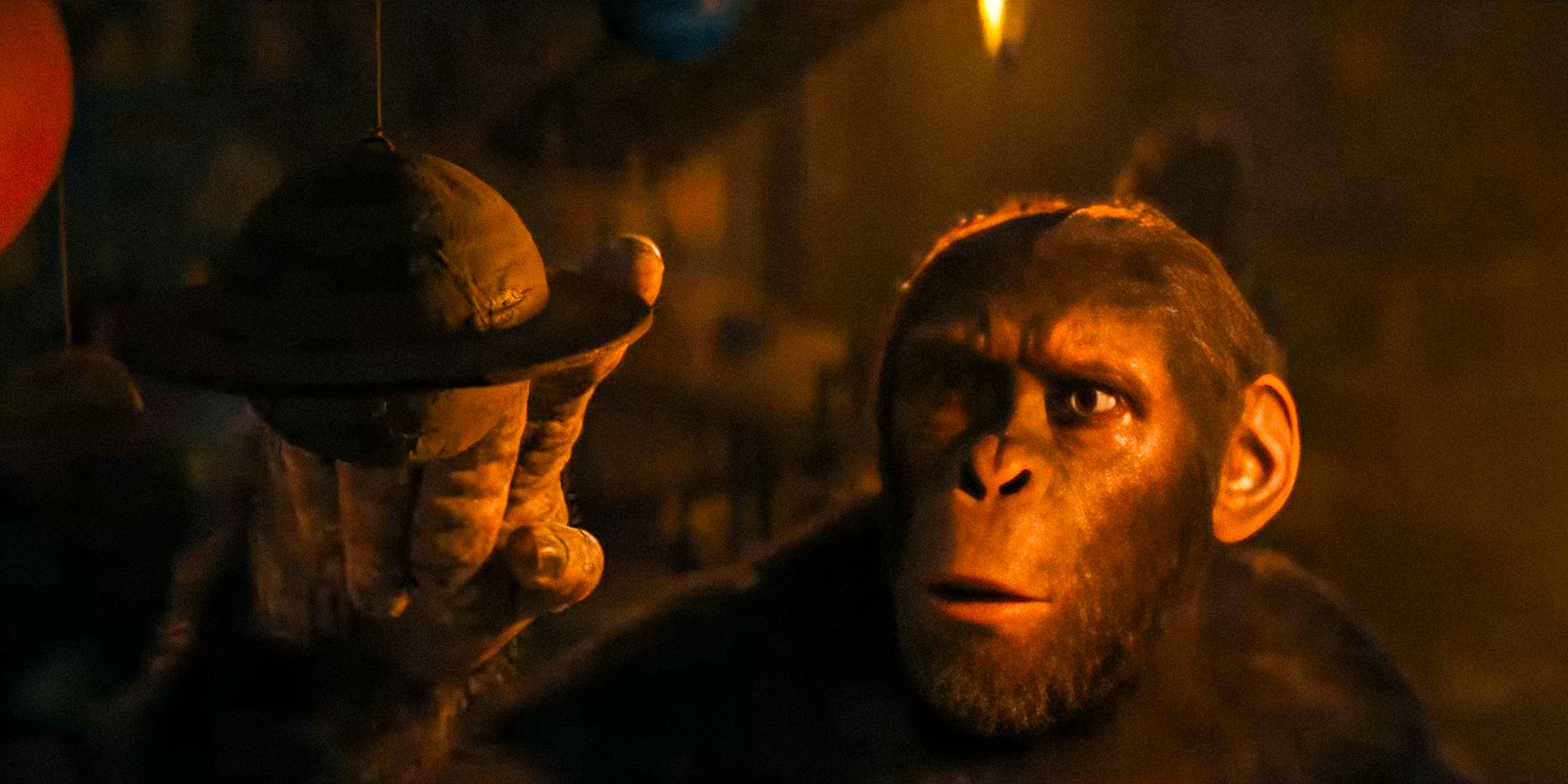 Noa curiously touching a mobile of the solar system in Kingdom of the Planet of the Apes