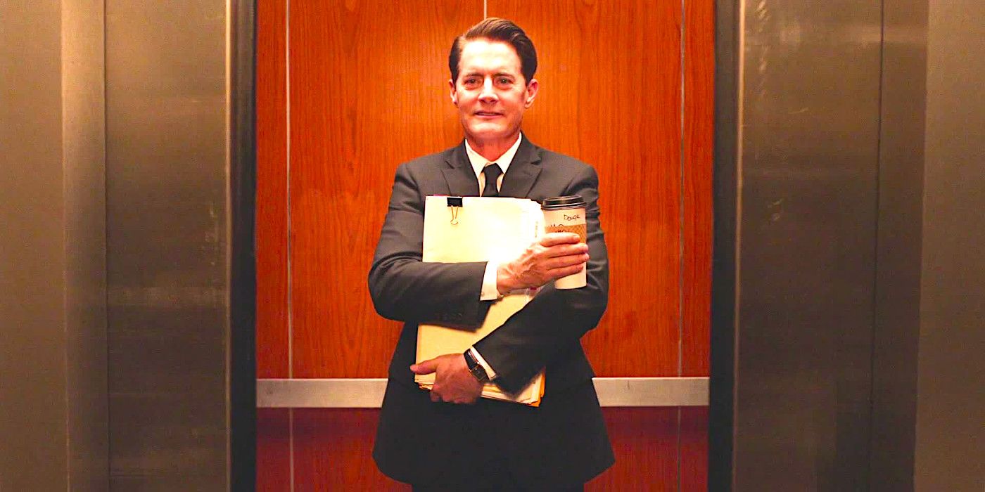 Kyle MacLachlan stands in an elevator, smiling and hugging a folder to his chest, while clutching a cup of coffee, in Twin Peaks: The Return