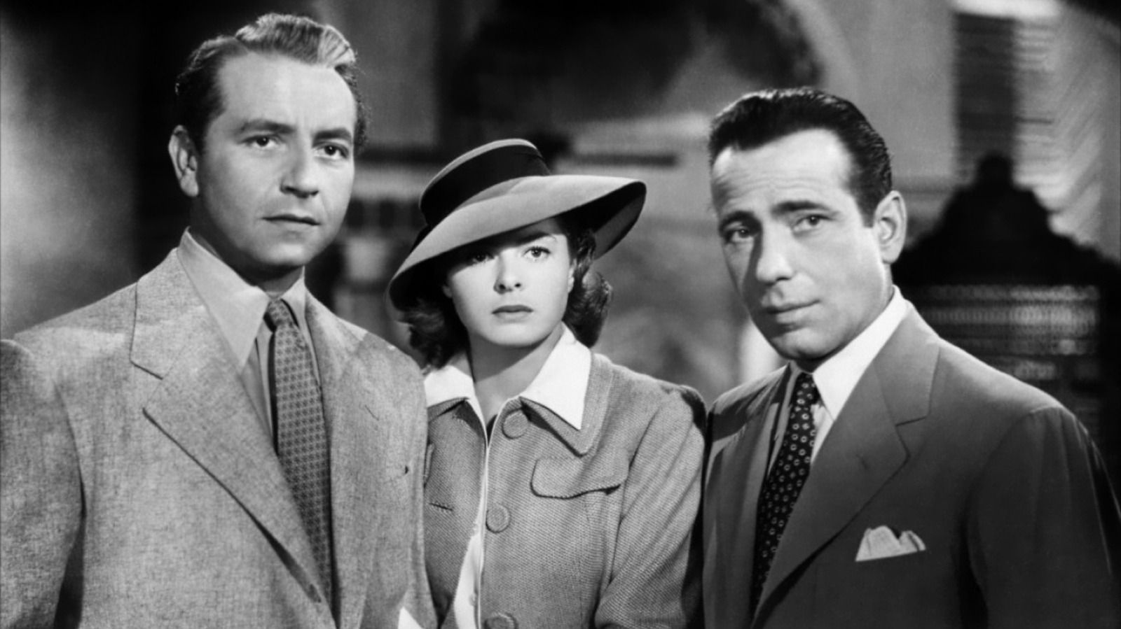 Paul Henreid, Ingrid Bergman, and Humphrey Bogart standing close together in Casablanca