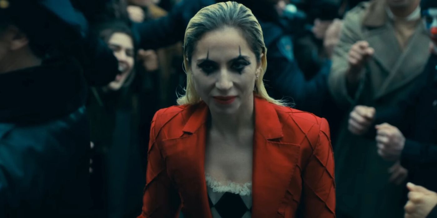 Lady Gaga walking up the stairs during a protest as Harley Quinn in Joker 2