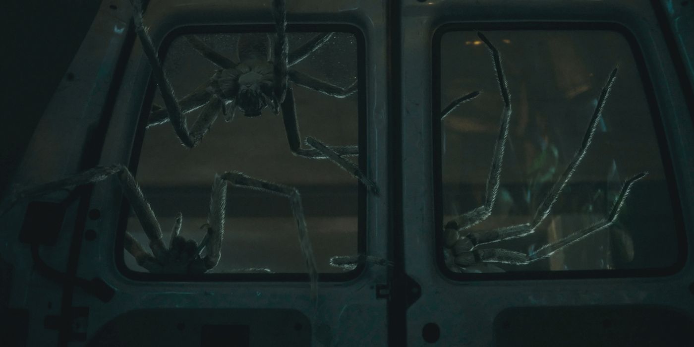 Large spiders breaking into a van's window in Infested