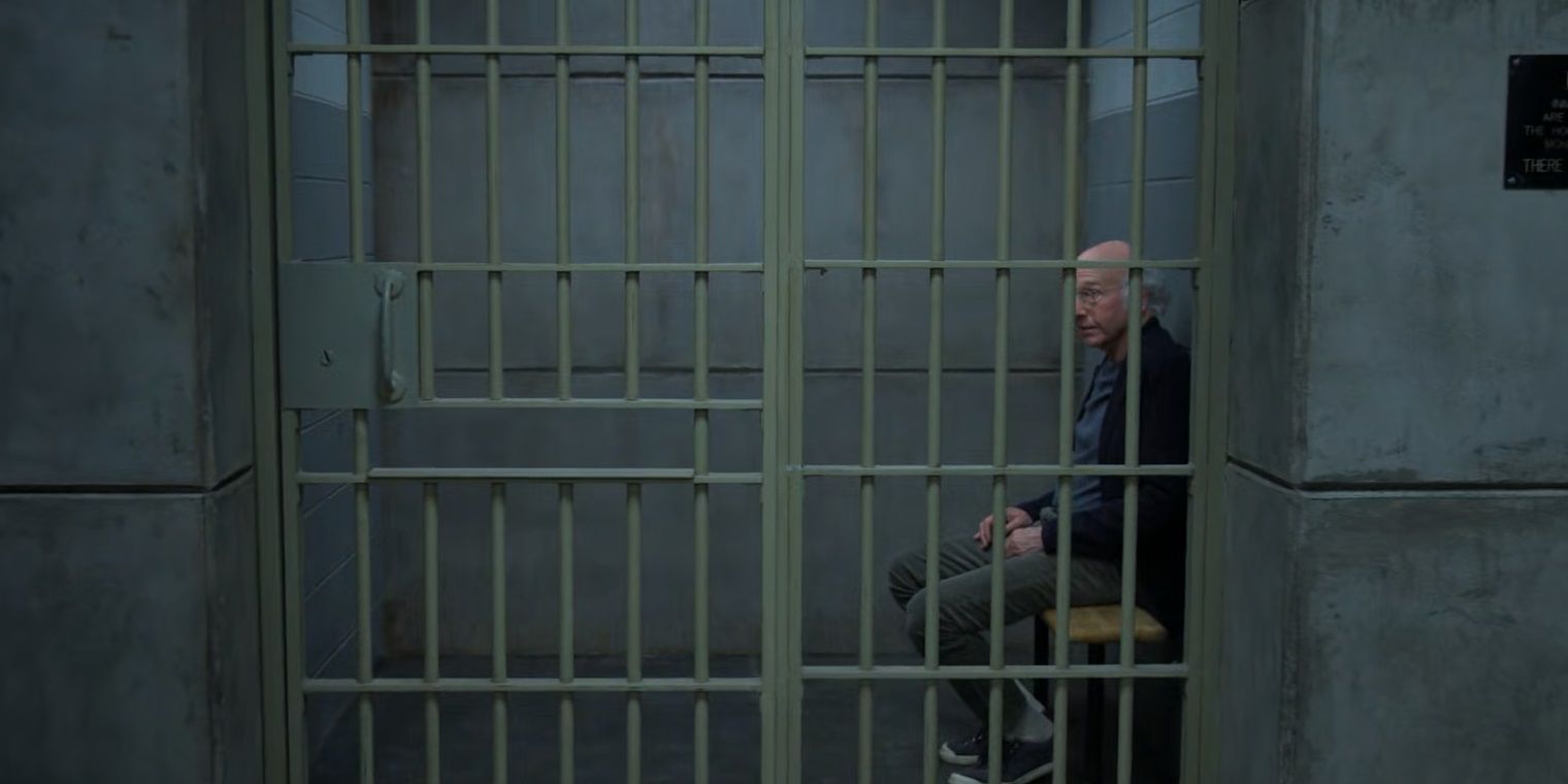 Larry sits in a jail cell in Curb Your Enthusiasm