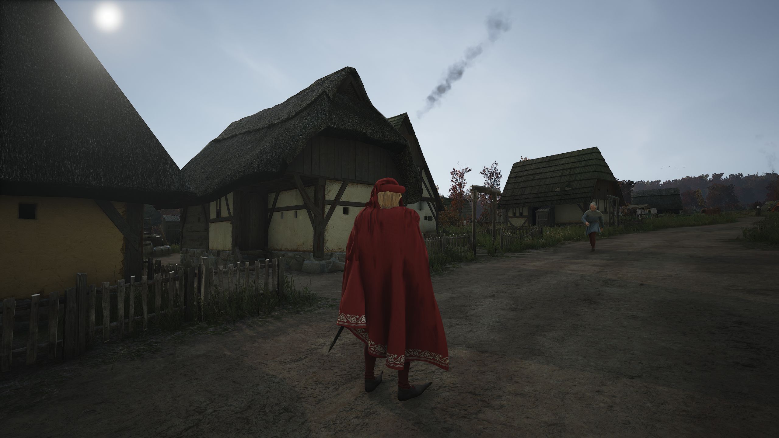 Jogador de Manor Lords observando um aldeão passear pela estrada de terra passando por lotes de Burgage