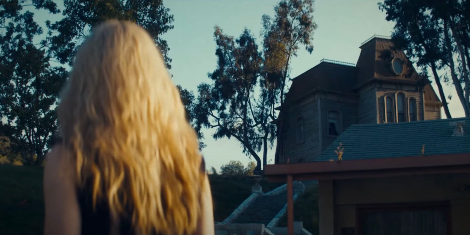 Maxine (Mia Goth) looks up at the Bates family house from Psycho in the MaXXXine trailer.