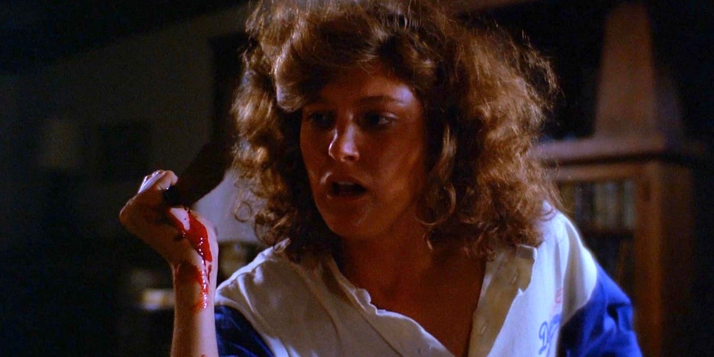 Michele Michaels is holding up a bloody knife. 