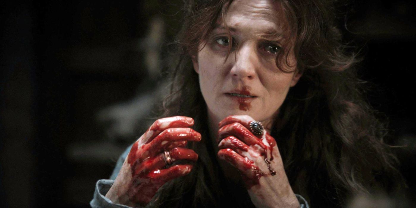 Michelle Fairley as Catelyn Stark with bloodied hands in Game of Thrones season 1 episode 2