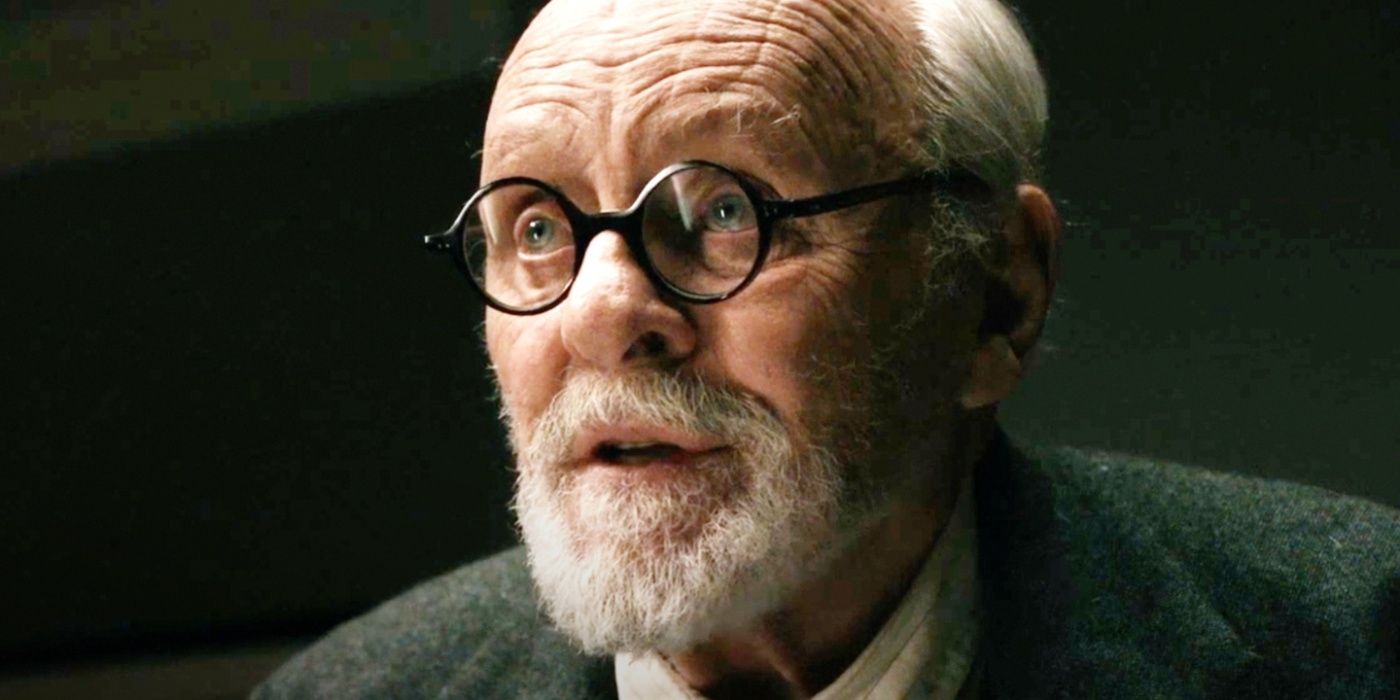 A close-up of Sigmund Freud (Anthony Hopkins) in a dark room in Freud's Last Session