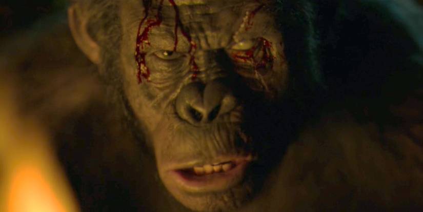 Koba with a bloody forehead in front of a fire in Dawn of the Planet of the Apes