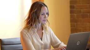 Jacqueline Sloane (Maria Bello) gazes intently at computer screen