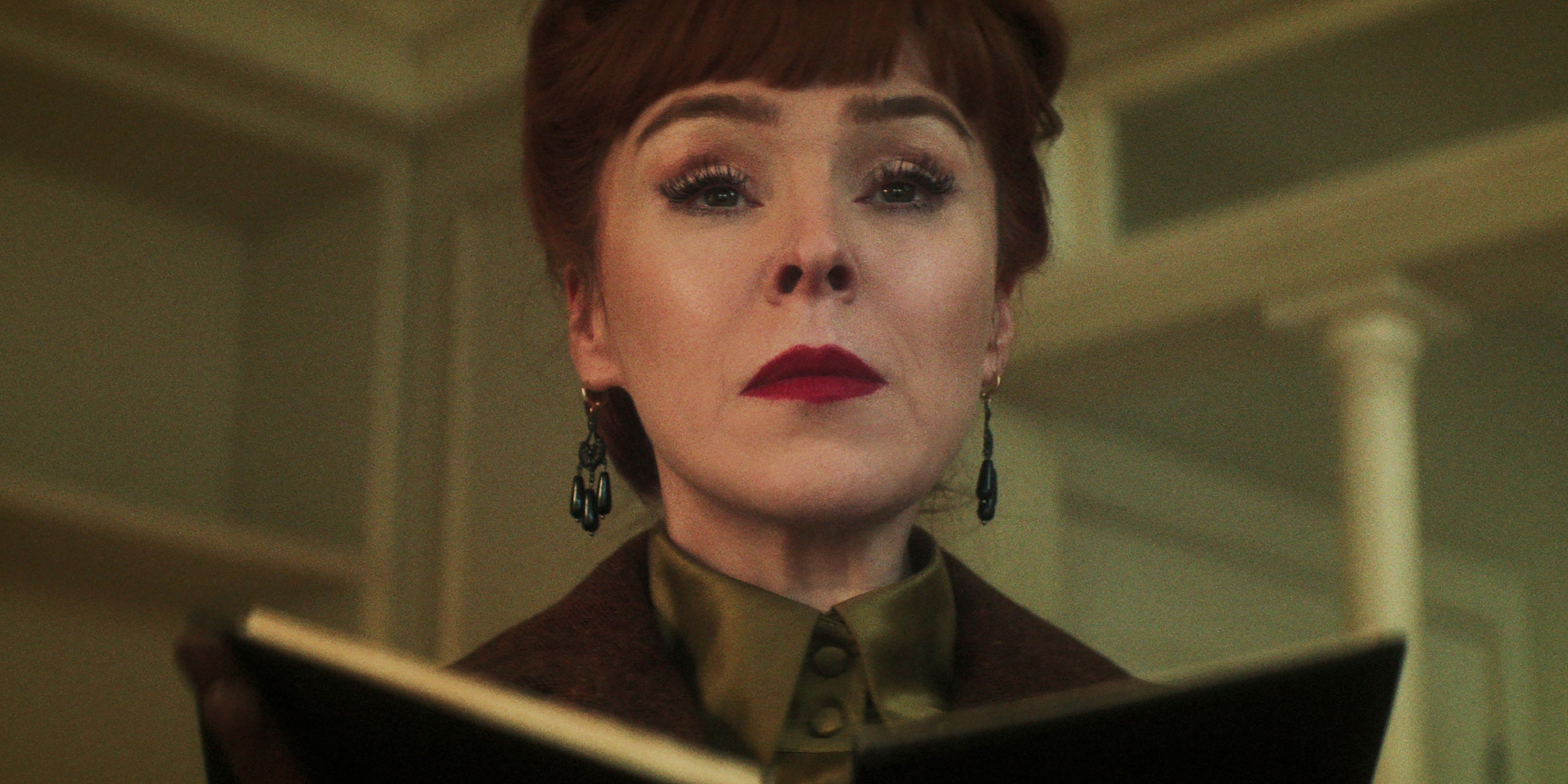 Ruth Connell as the Night Nurse holds a book in the Netflix series Dead Boy Detectives