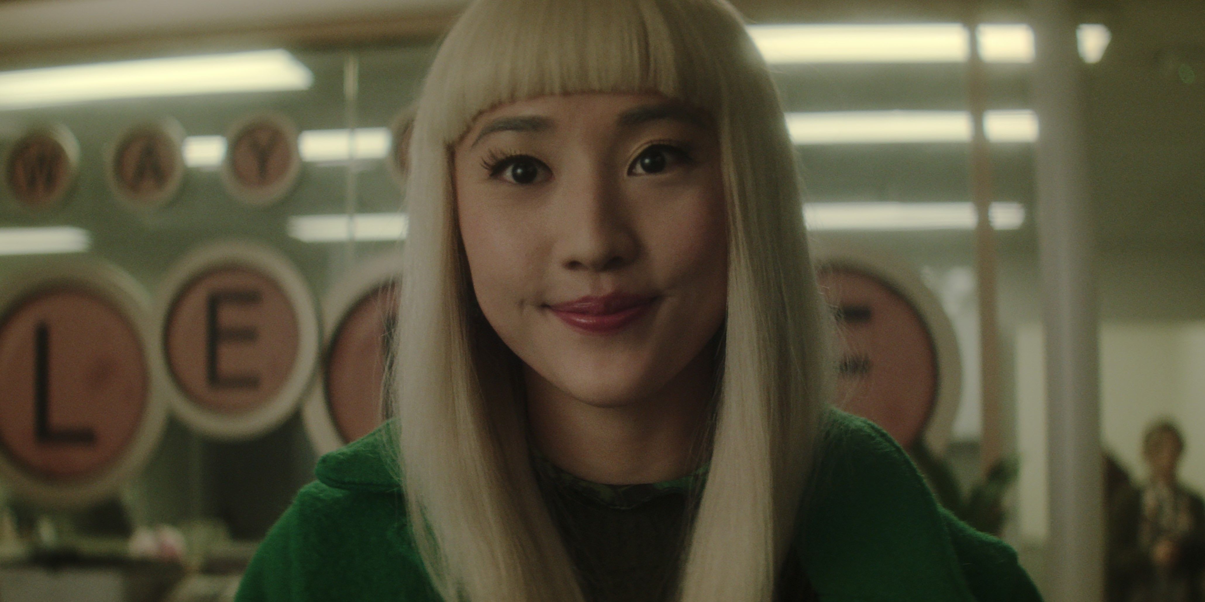 Niko smiles while wearing a green jacket in Dead Boy Detectives