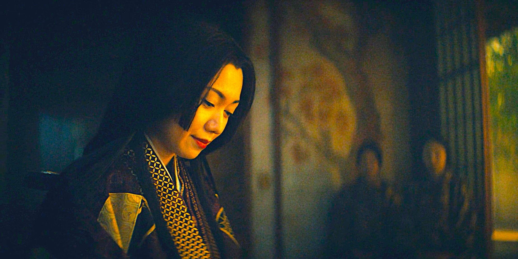Ochiba looks down with a serene expression in a scene from Shogun season 1