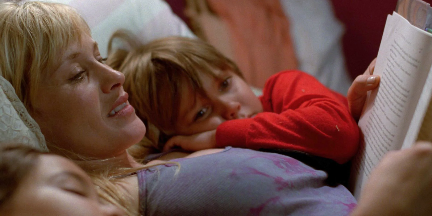 Patricia Arquette as Olivia and Ellar Coltrane as Mason reading a book together in Boyhood