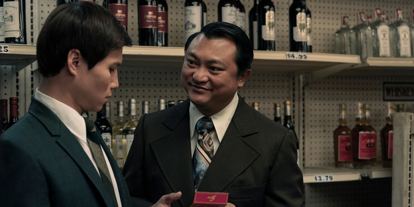 Phanxinê as the Crapulent Major showing the Captain something in a box in The Sympathizer