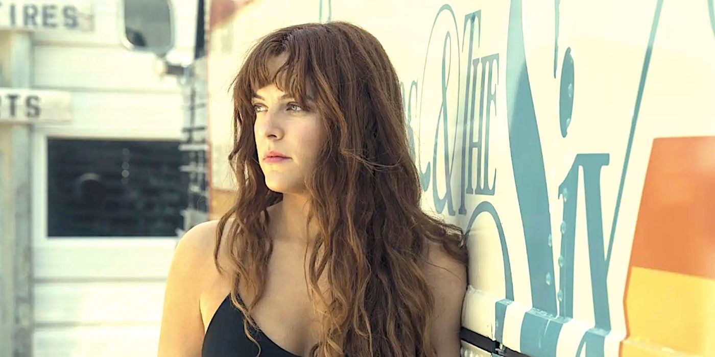 Riley Keough's Daisy Jones looks into the distance leaning against a van in Daisy Jones and the Six