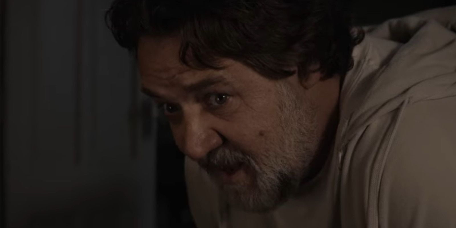 Russell Crowe in The Exorcism yelling and looking concerned 