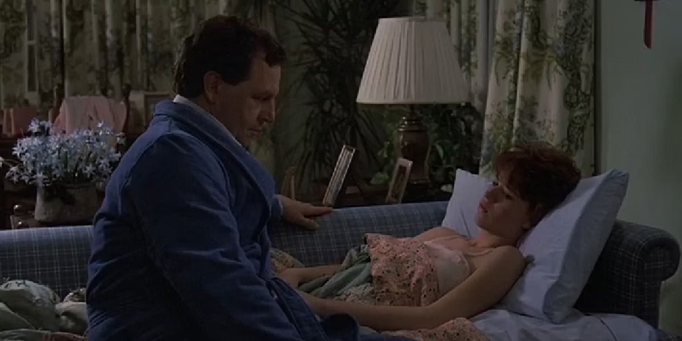 Sam and her dad talk on the couch in Sixteen Candles