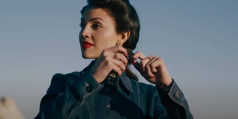 Eiza Gonzalez as Marjorie Stewart pulling the string off the grenade in The Ministry of Ungentlemanly Warfare