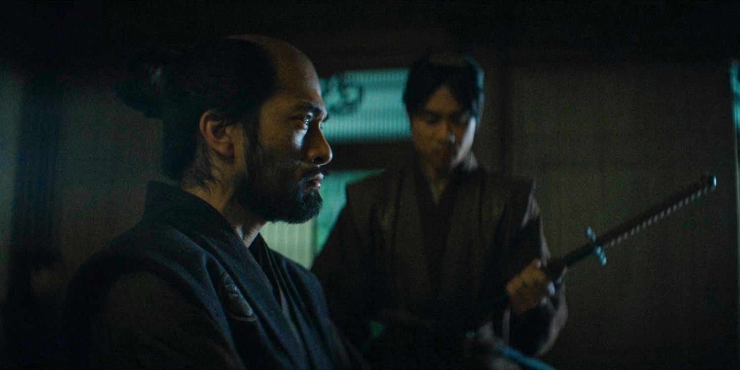 Buntaro seen in profile, with a man beside him about to hand him a sword in Shogun season 1 ep 8