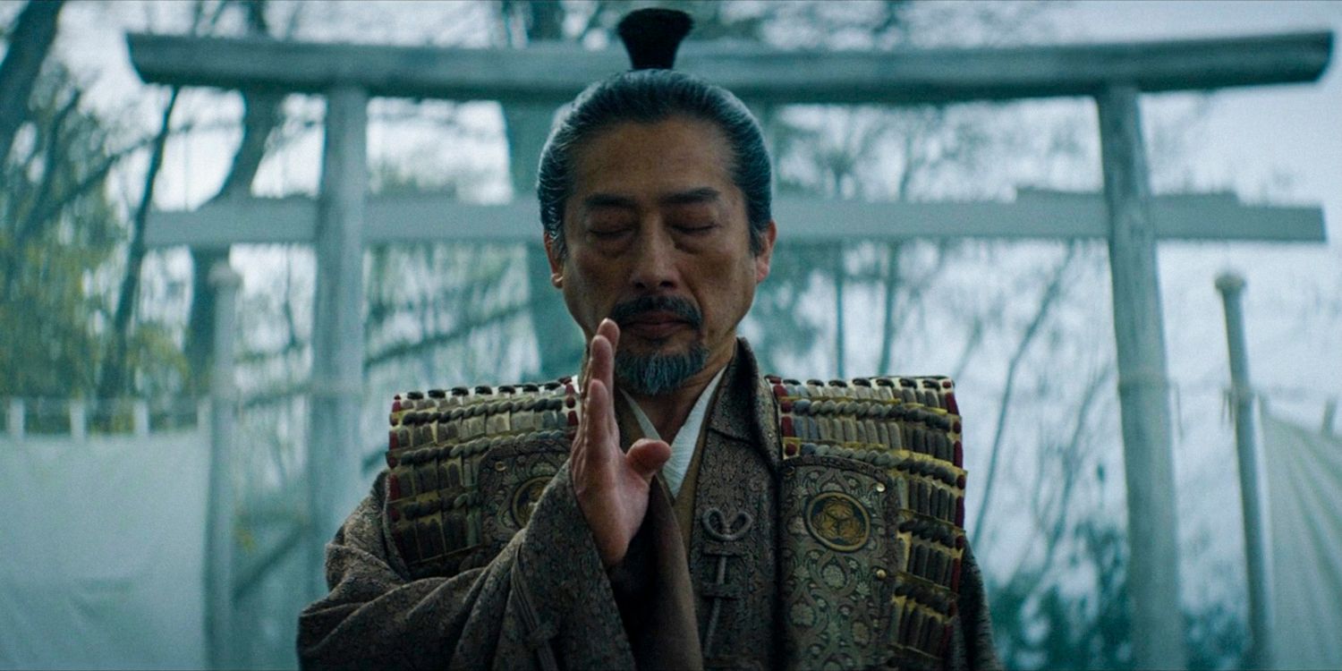 Toranaga with his eyes closed and his hand raised in prayer in Shogun season 1 ep 8