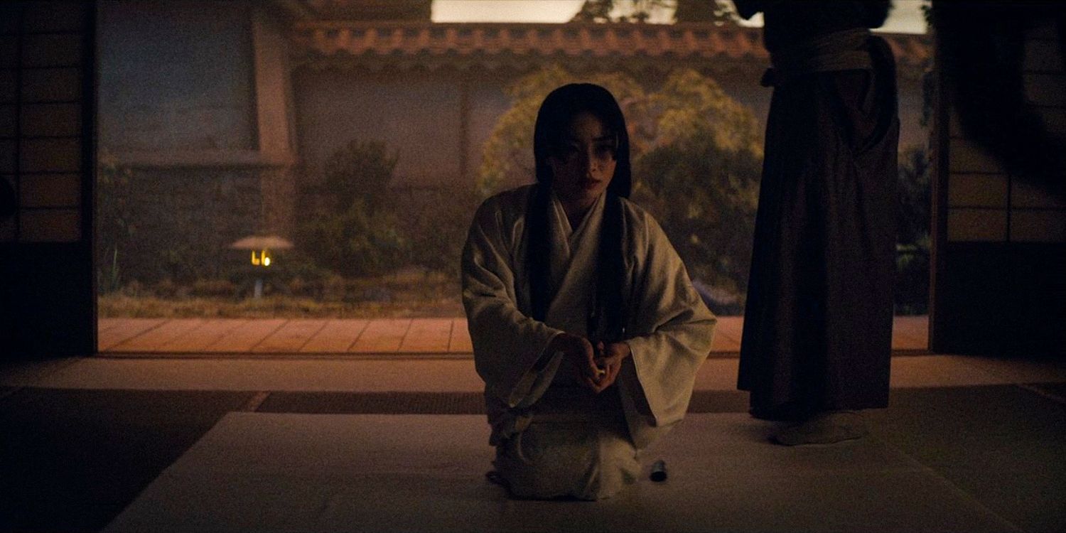 Mariko ajoelhada, colocando uma adaga no peito na 1ª temporada de Shogun, episódio 9 