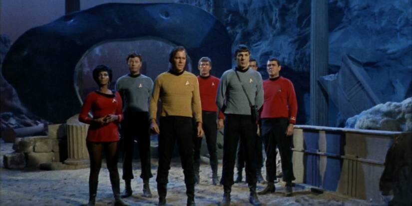 Captain Kirk and the Enterprise crew standing on alien planet