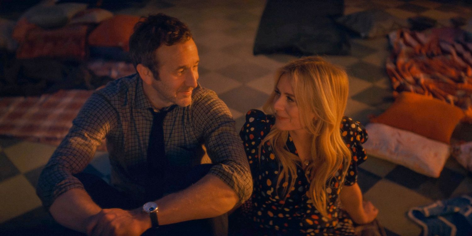 Dusty (Chris O'Dowd) and a blonde woman looking at each other romantically in The Big Door Prize season 2