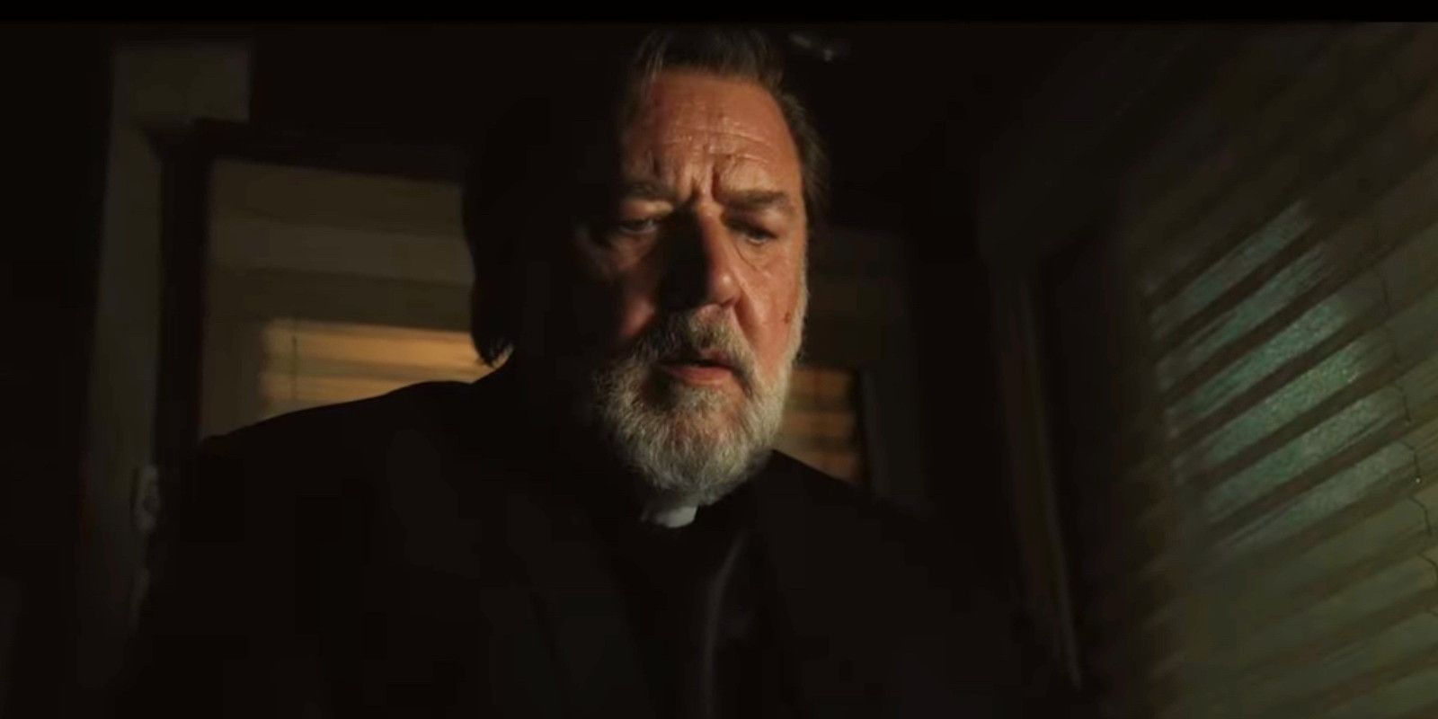 The Exorcism Russell Crowe looking concerned in a dark room 