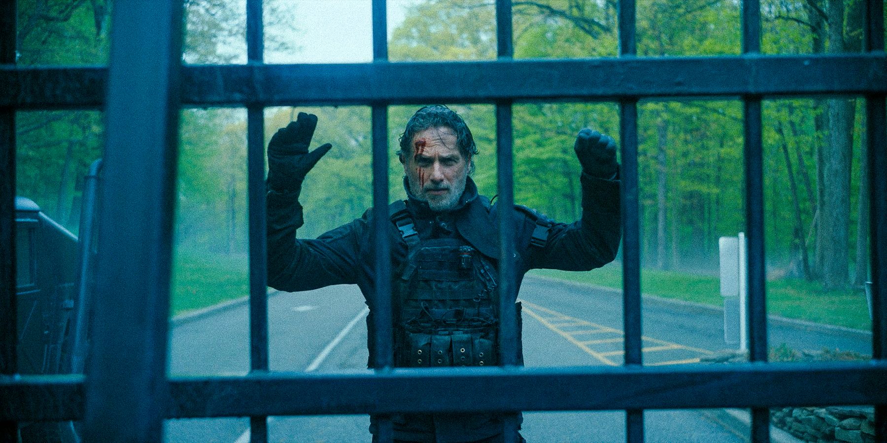 Rick with his hands raised at the entrance of the Cascadia base in The Walking Dead: The Ones Who Live.