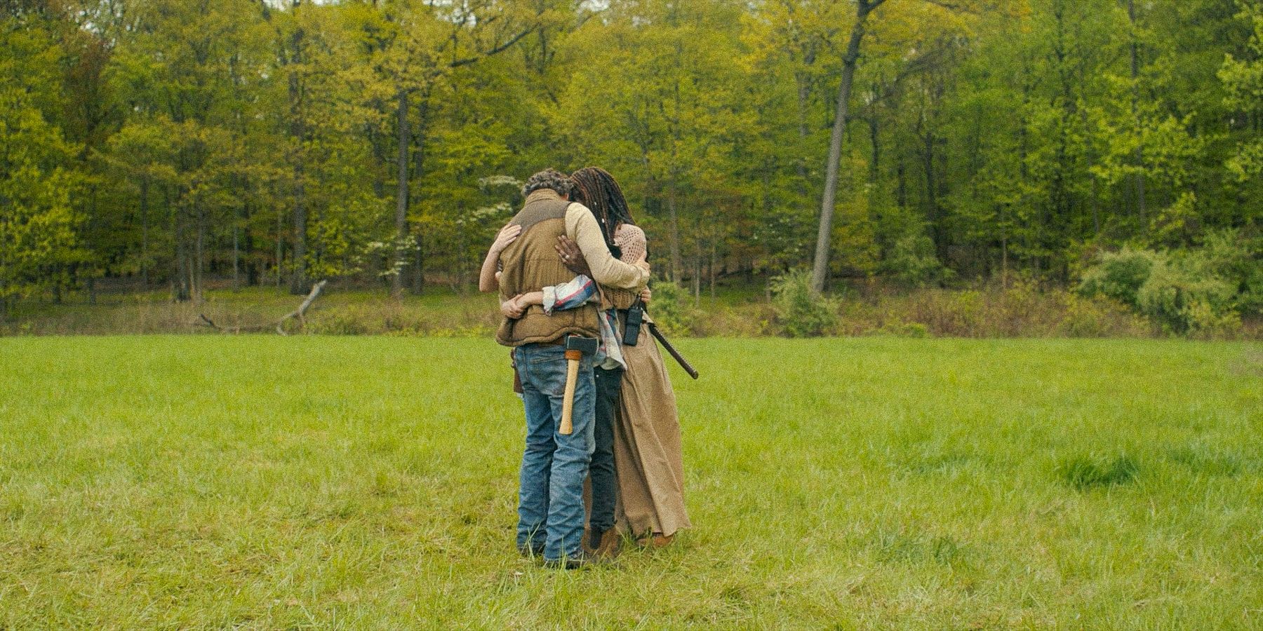 Rick and Michonne hugging their children in an open field in The Walking Dead: The Ones Who Live.
